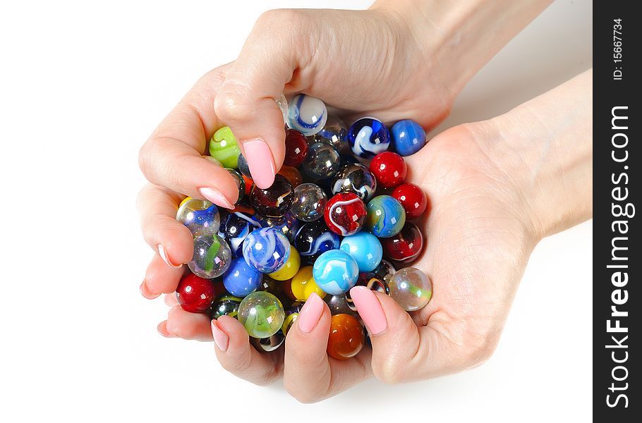 Beautiful hands with perfect manicure holding many colorfull balls