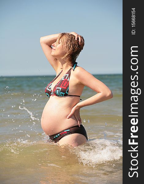 Pregnant woman enjoying in water. Pregnant woman enjoying in water