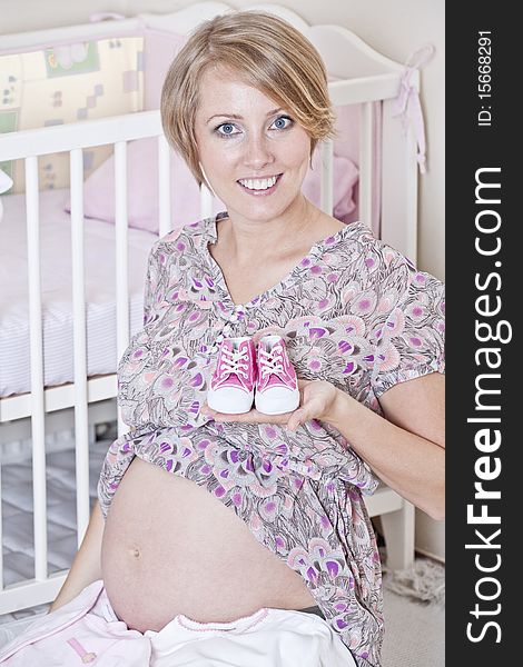 Beautiful pregnant woman prepares for the baby. Beautiful pregnant woman prepares for the baby