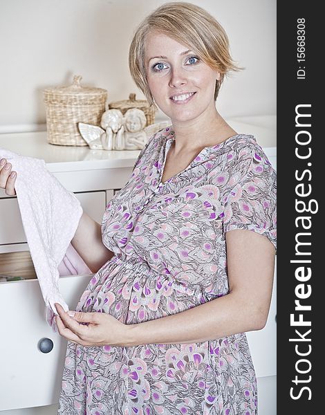 Beautiful pregnant woman prepares for the baby. Beautiful pregnant woman prepares for the baby