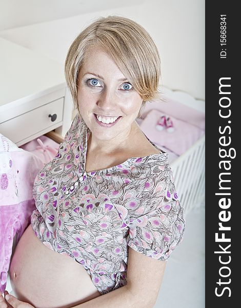 Beautiful pregnant woman prepares for the baby. Beautiful pregnant woman prepares for the baby