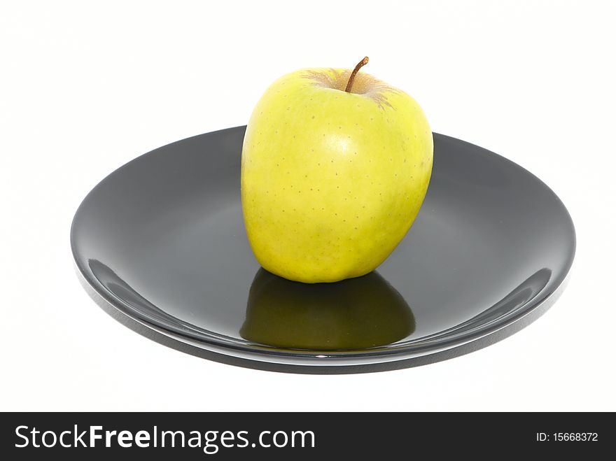 Green apple on the black plate