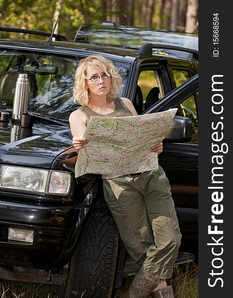 A woman driver reading a road map. A woman driver reading a road map