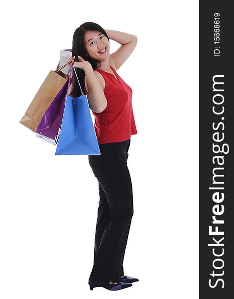 An Asian woman holding multiple shopping bags isolated in white background. An Asian woman holding multiple shopping bags isolated in white background