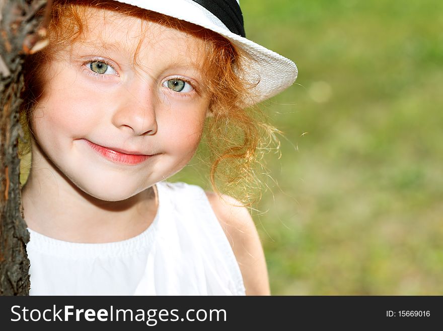 Portrait of a cute red-haired girl having a rest outdoor. Portrait of a cute red-haired girl having a rest outdoor.