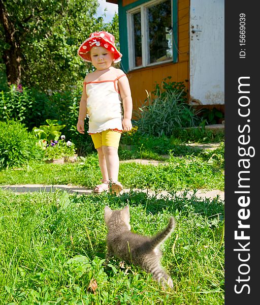 A little girl waits for a small kitten