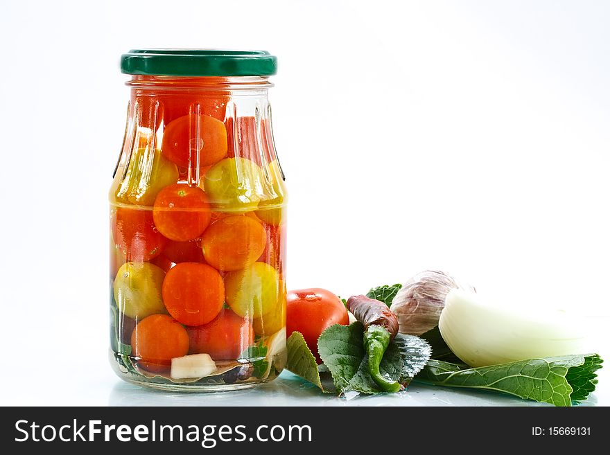 Marinated tomatoes in the bank with spices