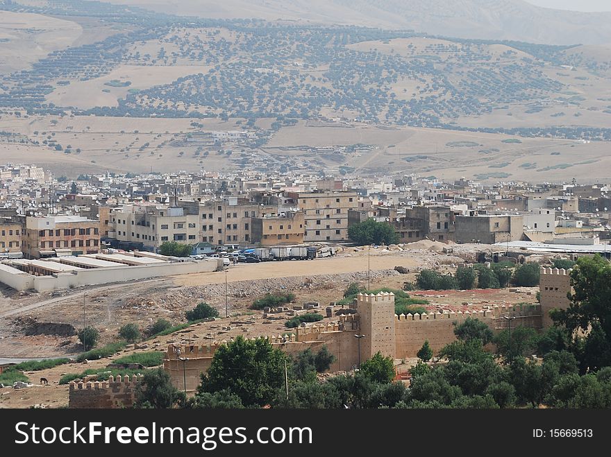 A view of Fes with the old city wall in the foreground. A view of Fes with the old city wall in the foreground