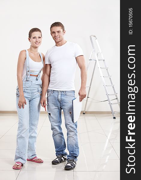 A smiling couple in a new apartment