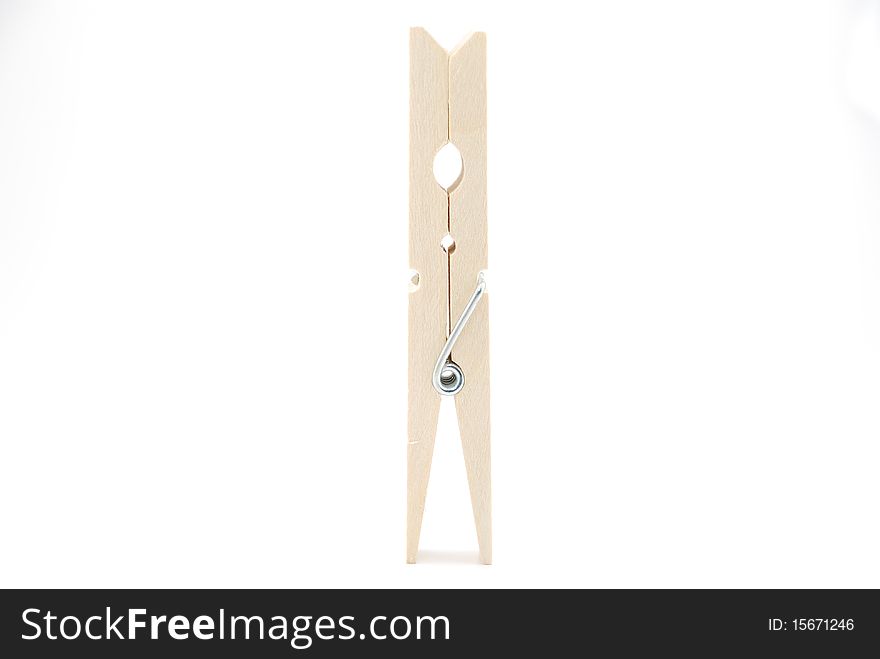 The wooden clothespin stand-up on the white background