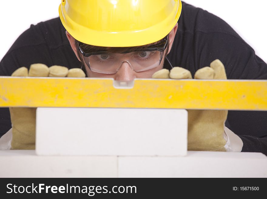 Construction worker with level on white background