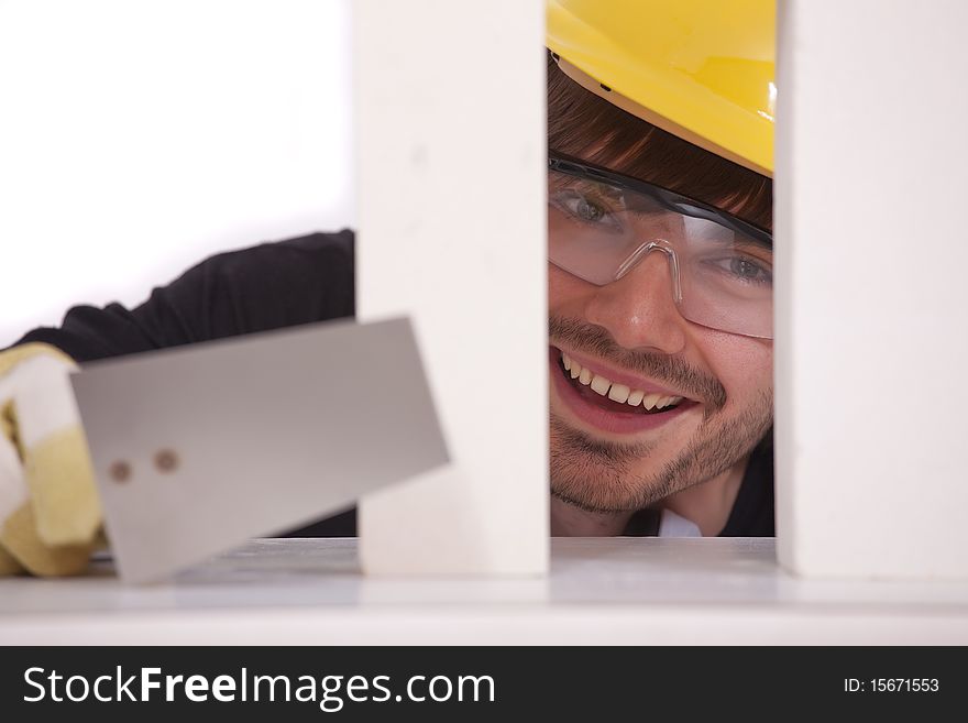 Happy bricklayer with spade and white brick stones