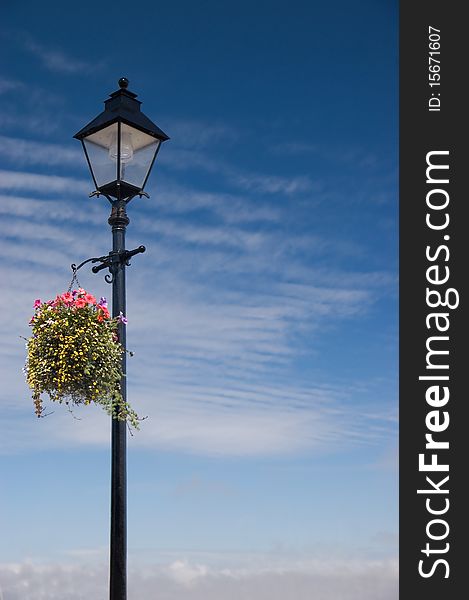 A Colourful Vintage lamp post scene wih hanging basket and Copy Space