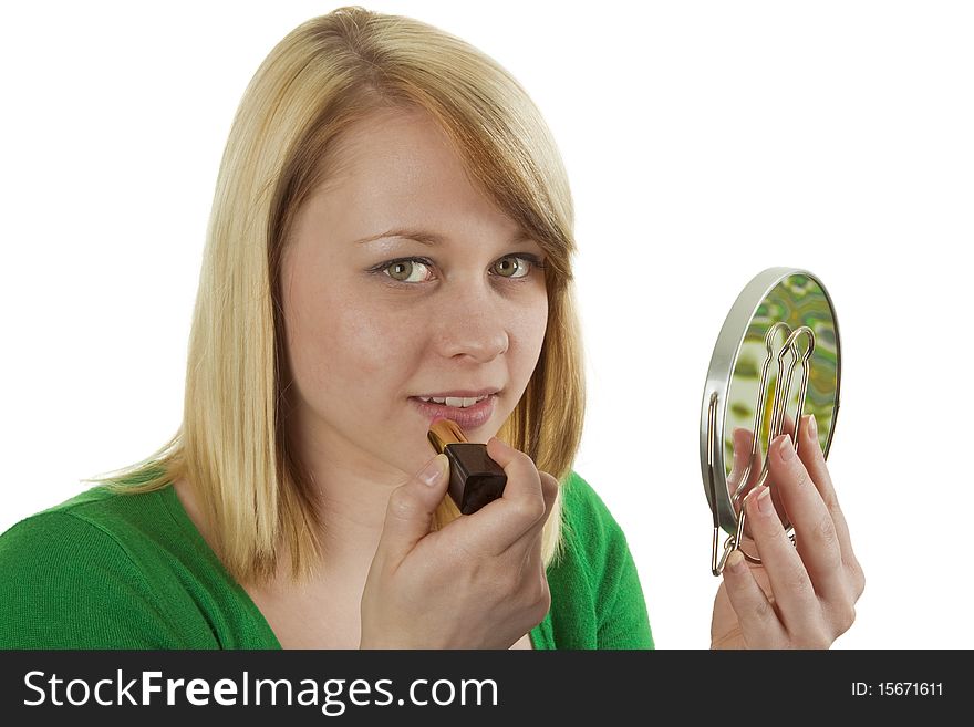 Young woman paints lips with lipstick isolated on white