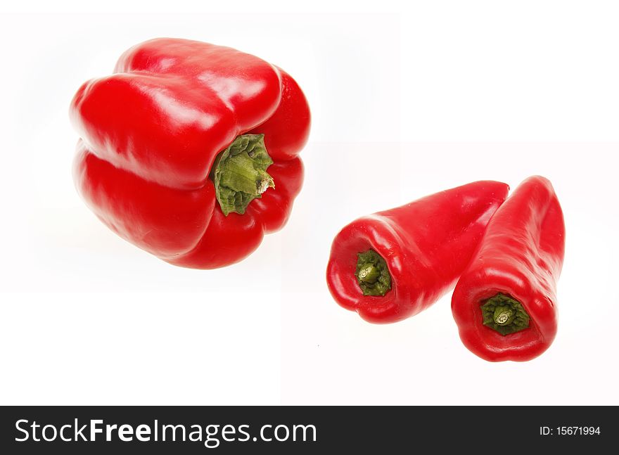 Ripe red peppers on white background.