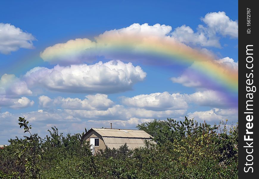 Rainbow And Summers Cloudy Sky