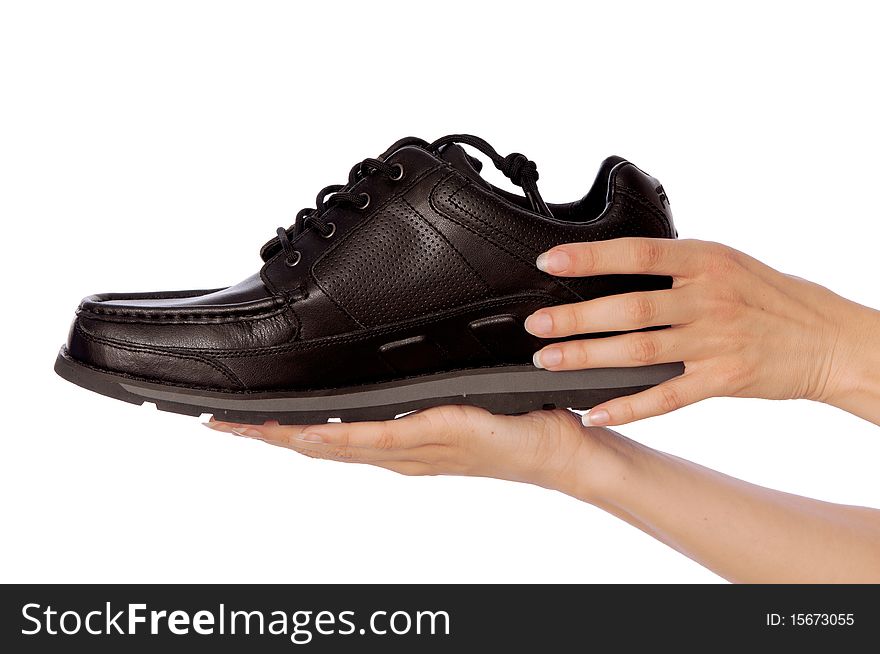 New model of black urban footwear in saleswoman's hands. New model of black urban footwear in saleswoman's hands