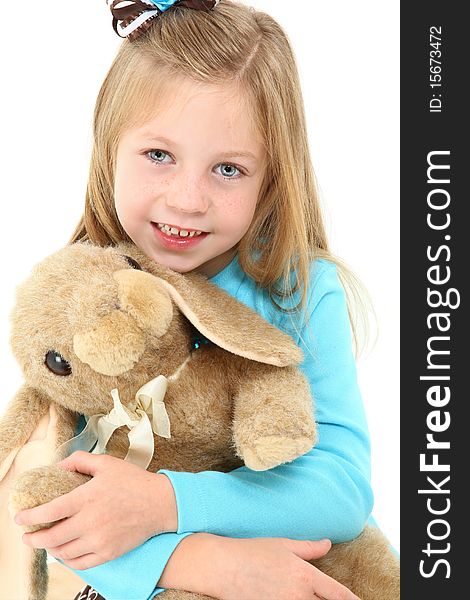 Adorable five year old american girl with brown bunny rabit over white. Adorable five year old american girl with brown bunny rabit over white