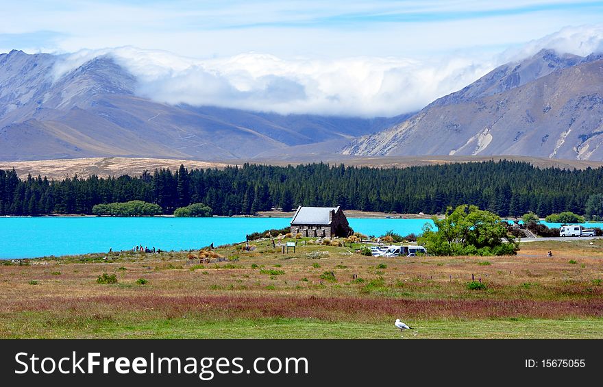 Turquoise waters of glacial Lake Tekapo and The Church of Good Shepard. South Island, New Zealand