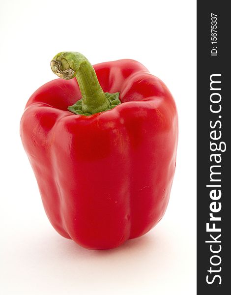 Bright ripe Red Pepper with thick green stem. Bright ripe Red Pepper with thick green stem