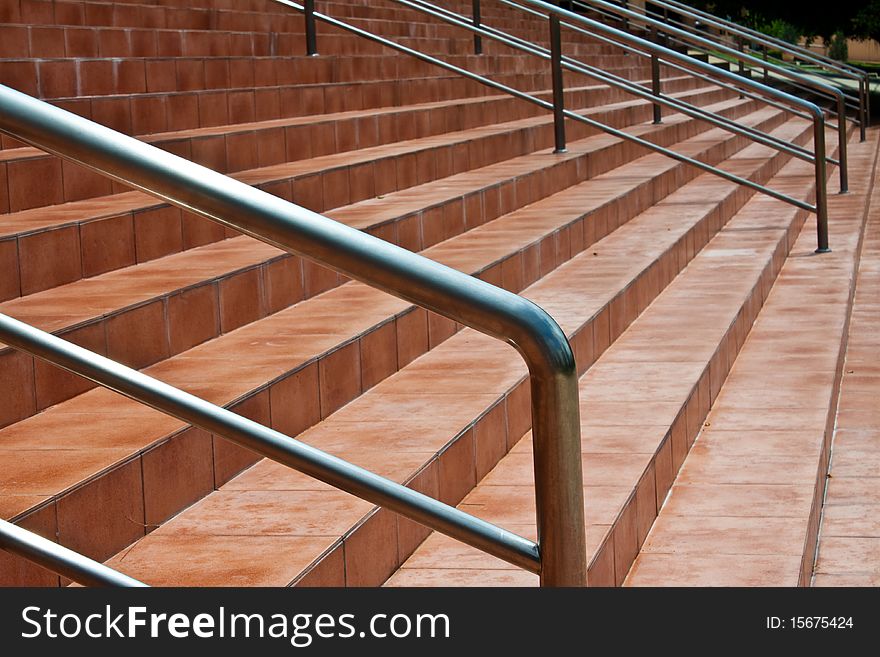 The brown stair have metal handle