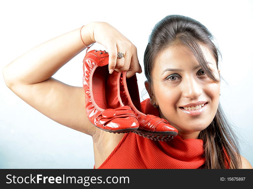 Girl holding red bellies for advertising shoot.