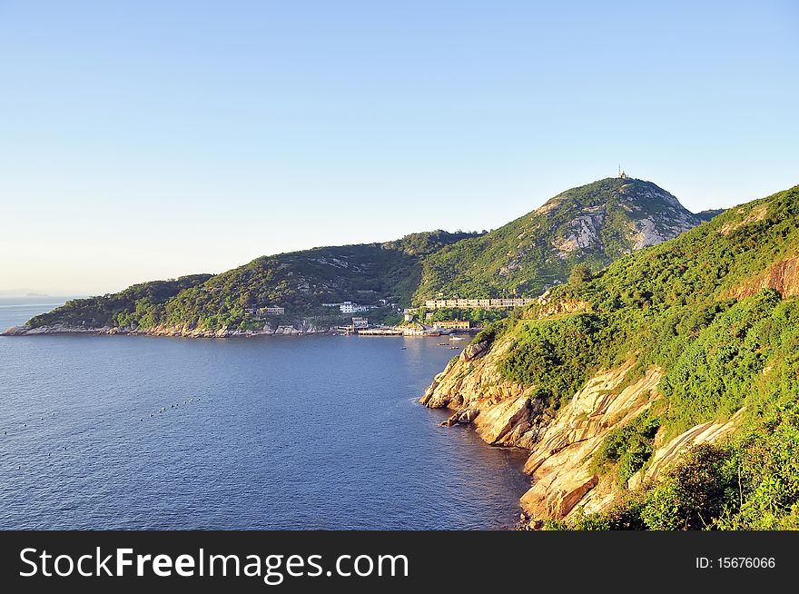 Sunset ray on an islands with buildings,blue sea and sky. Sunset ray on an islands with buildings,blue sea and sky