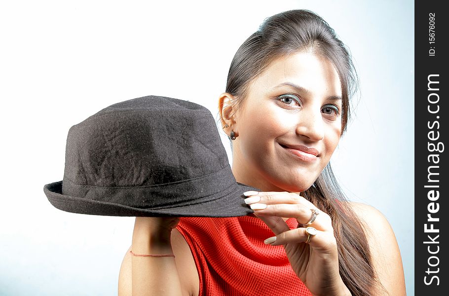 Bold girl with black hat in studio. Bold girl with black hat in studio.