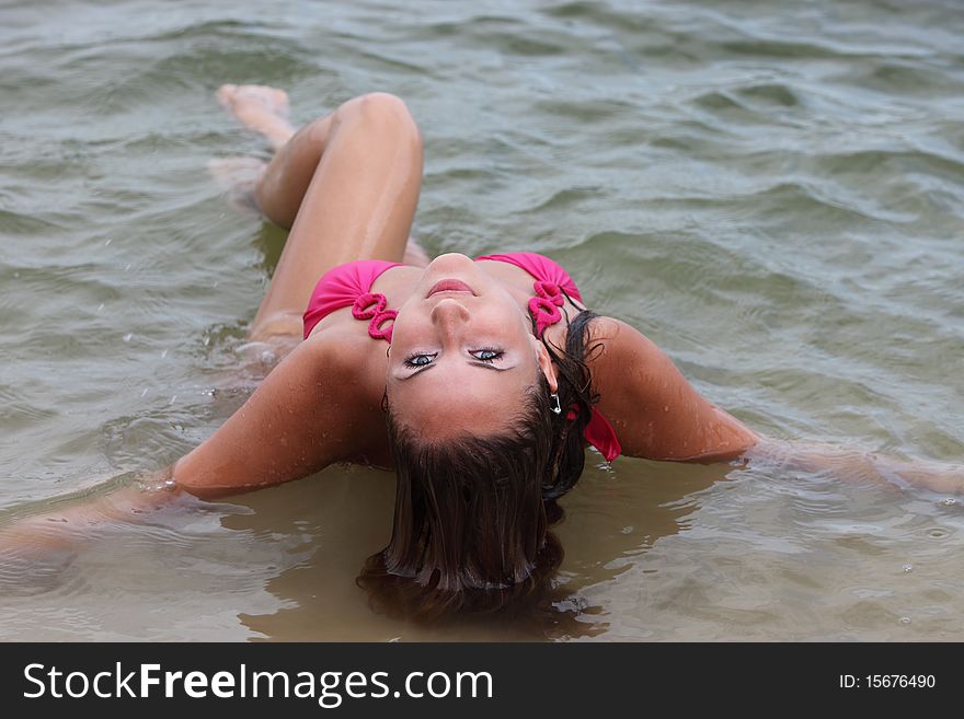 Attractive woman in the swimsuit on the river