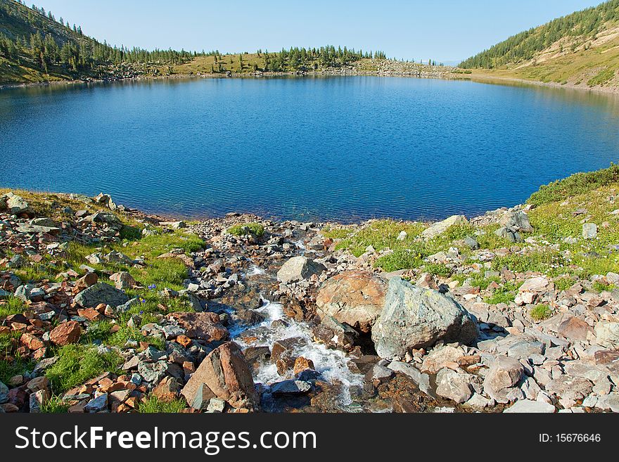 Clean stream and lake in mountain, altai