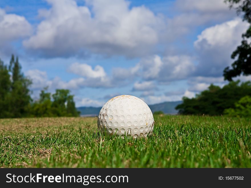 Golfball On Course And Blue Sky