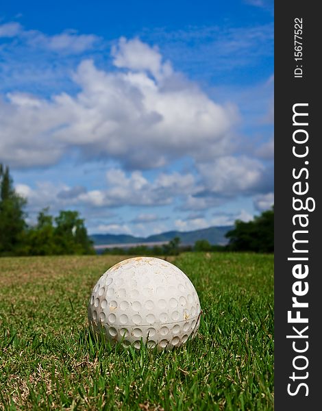 Golfball On Course And Blue Sky