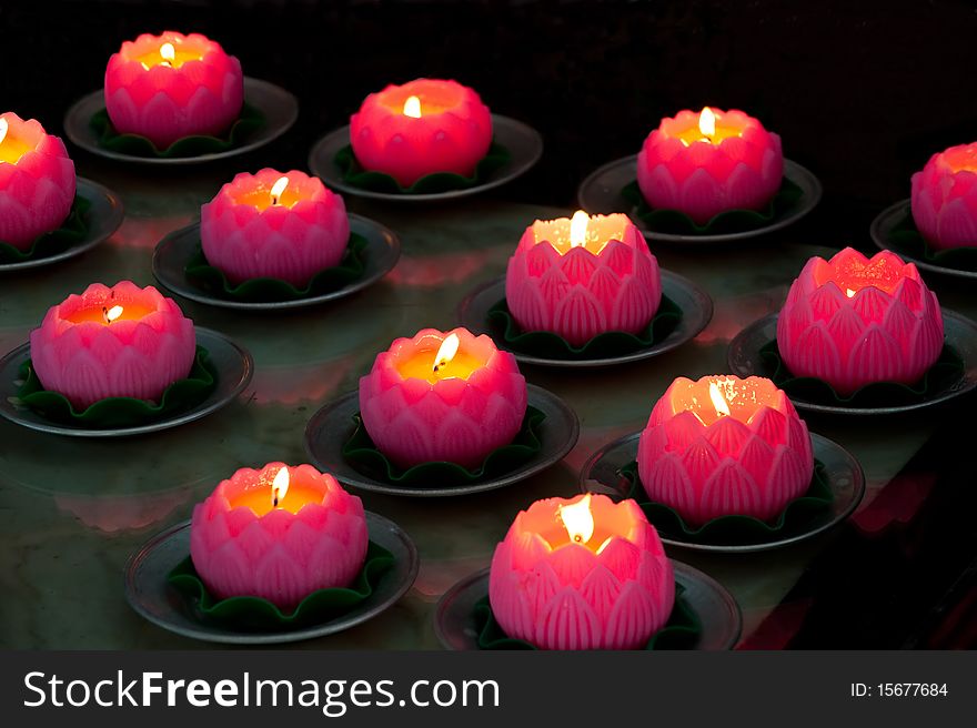 Pink candles in lotus form