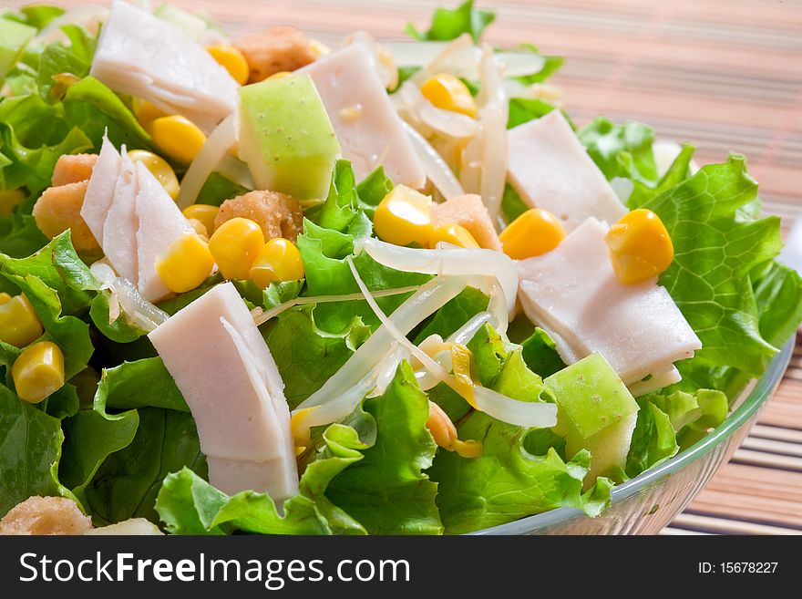 Corn salad with green lettuce and ham