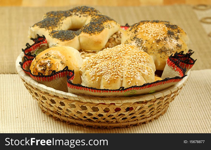 Basket full of various buns with seeds and herbs. Basket full of various buns with seeds and herbs