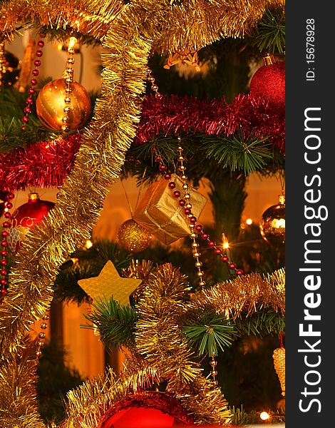 Ornamented Christmas tree  with red and golden chains and glass balls. Ornamented Christmas tree  with red and golden chains and glass balls