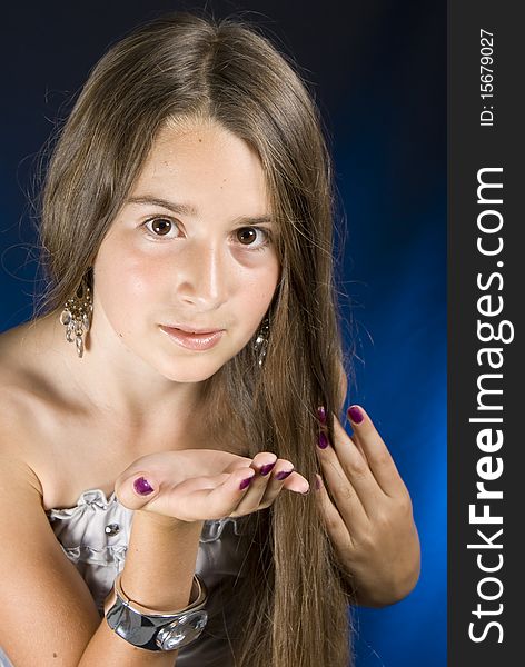 Portrait of a cute young female blowing a kiss towards - Dark background. Portrait of a cute young female blowing a kiss towards - Dark background