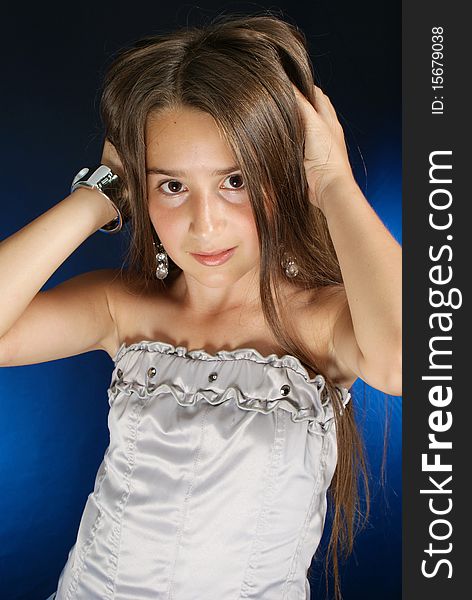 Young girl posing with hands in her hair
