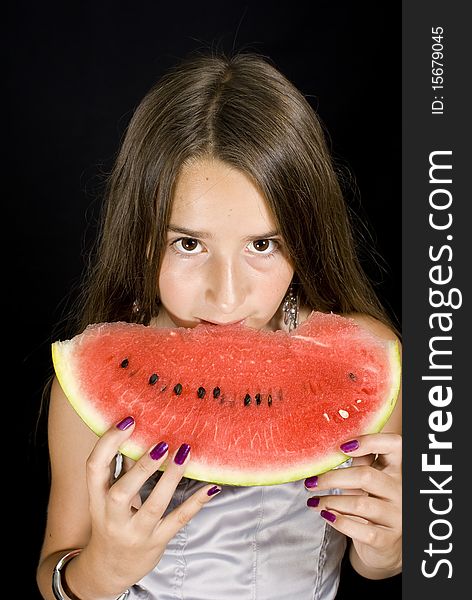 Girl eating Watermelon on black background