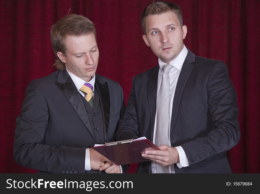 Two actors with clipboard discussing on the stage. Two actors with clipboard discussing on the stage