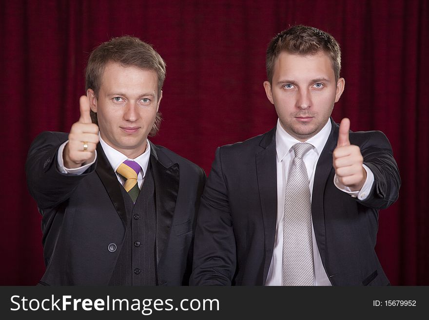 Two male actors holding thumbs up on the stage
