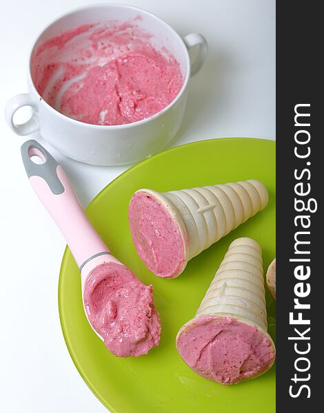 Homemade strawberry and banana ice cream. In edible horns on a plate