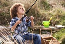 Young Boy Fishing At Seaside Royalty Free Stock Photo
