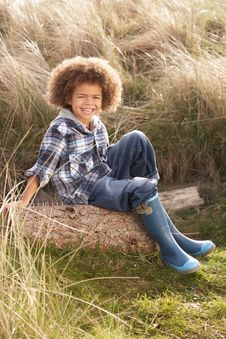 Young Boy Putting On Wellington Boots Stock Photography Young Boy Putting On Wellington Boots Stock Photography