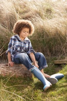 Young Boy Putting On Wellington Boots Royalty Free Stock Photos Young Boy Putting On Wellington Boots Royalty Free Stock Photos