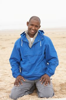 Man Relaxing On Beach In Autumn Clothing Royalty Free Stock Photos Man Relaxing On Beach In Autumn Clothing Royalty Free Stock Photos