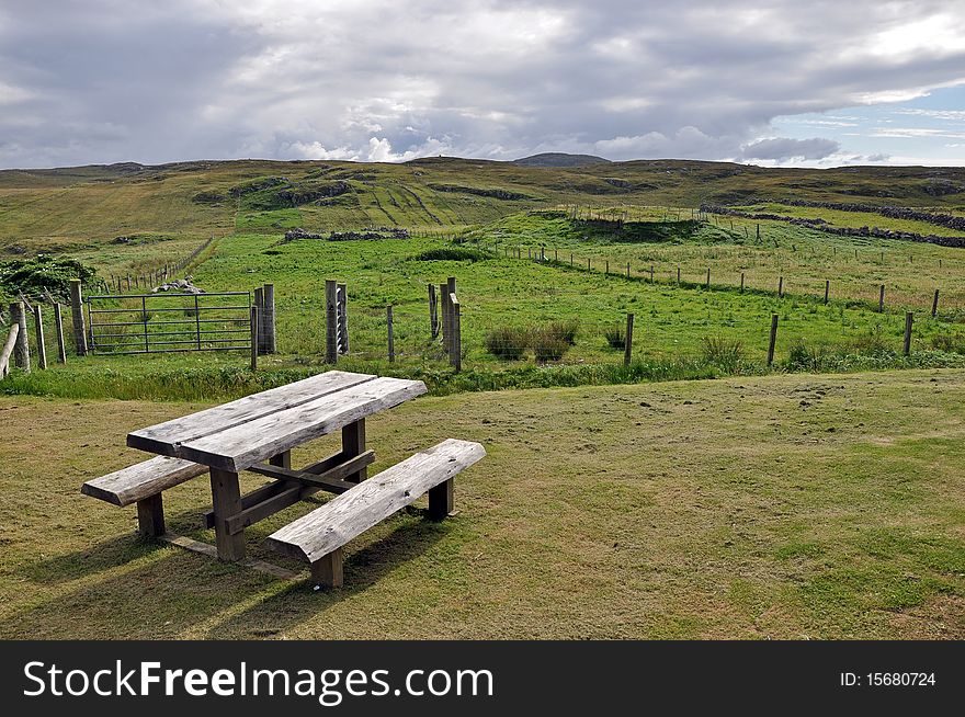 Wooden picnic table in a field. Wooden picnic table in a field