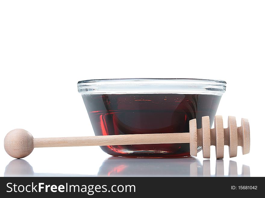 Honey in glasswares with wooden honey dipper.