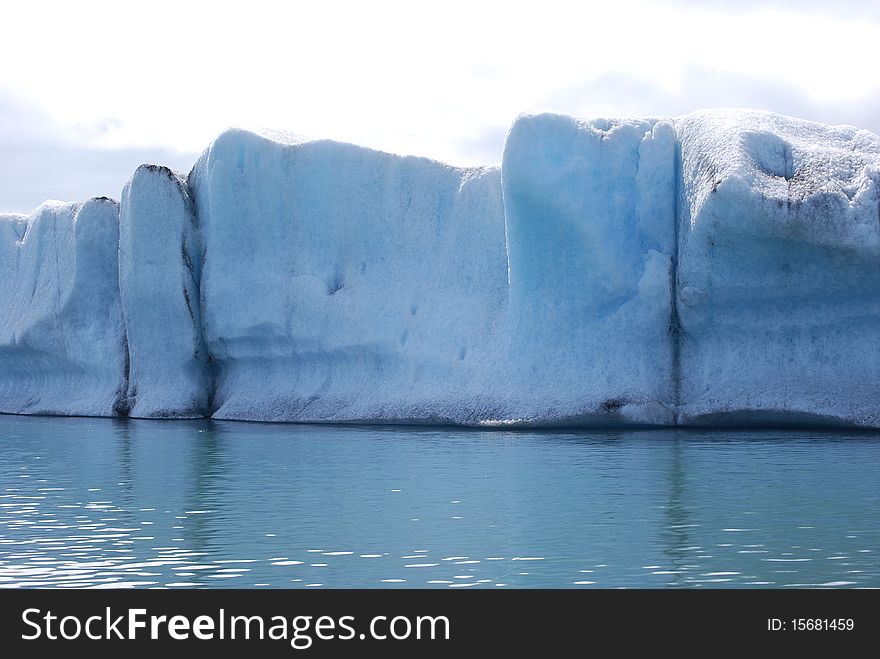 Icebergs floating in the glacial lagoon at JÃ¶kulsÃ¡rlÃ³n in Iceland