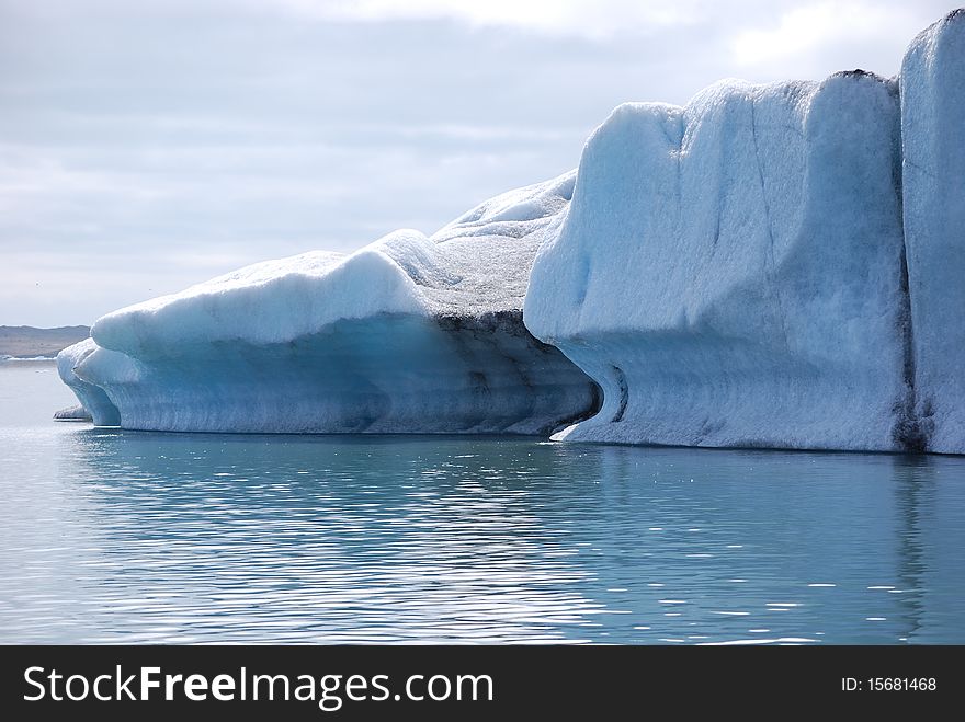 Icebergs floating in the glacial lagoon at JÃ¶kulsÃ¡rlÃ³n in Iceland